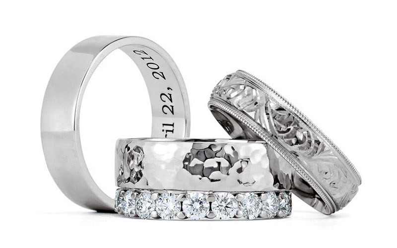 Three wedding bands, hand-engraved, diamond-set and hammered finish, from Lanes Fine Jewellery, Stamford